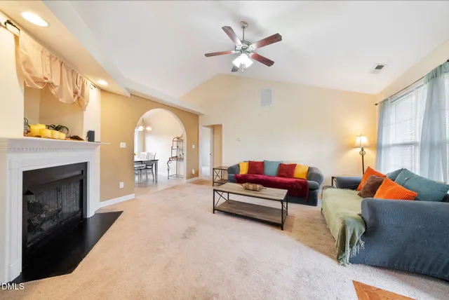 a living room with furniture and a fireplace