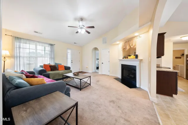 a living room with furniture a fireplace and a window