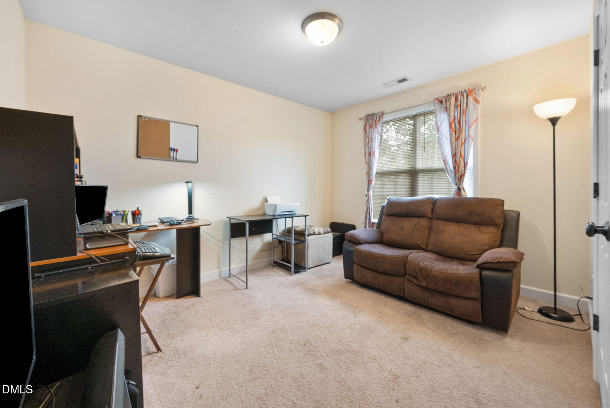 25 Lawrence Court Smithfield, NC 27577 - Photo 22 of 41 a living room with furniture a flat screen tv and a window