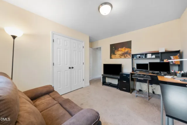 a livingroom with workspace and a couch