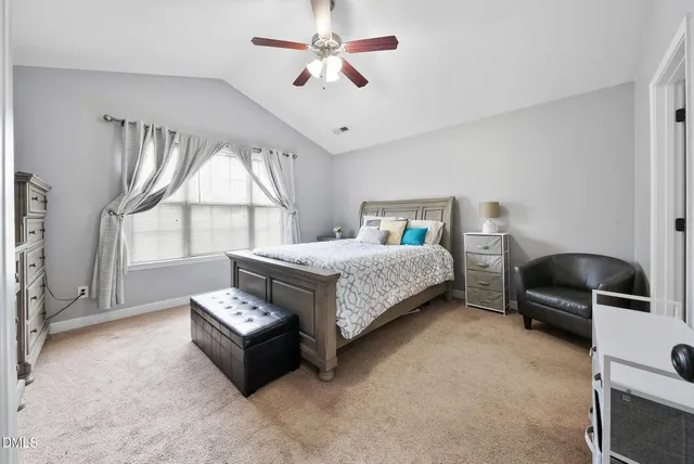 a bedroom with a bed a window and couch