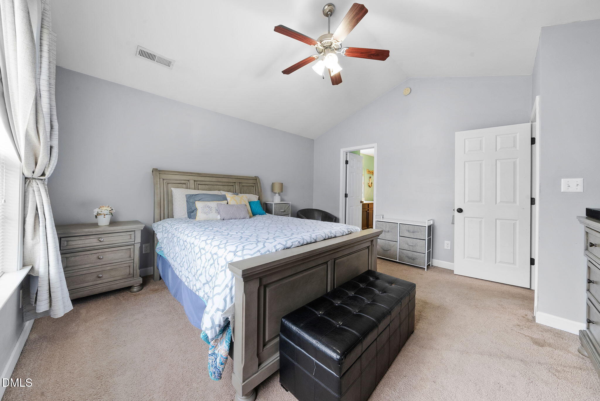 25 Lawrence Court Smithfield, NC 27577 - Photo 28 of 41 a bedroom with a bed and a chandelier