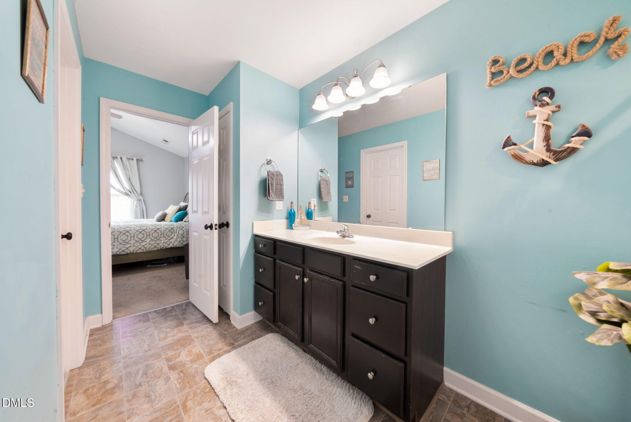 25 Lawrence Court Smithfield, NC 27577 - Photo 32 of 41 a en suite bathroom with a double vanity sink and a mirror
