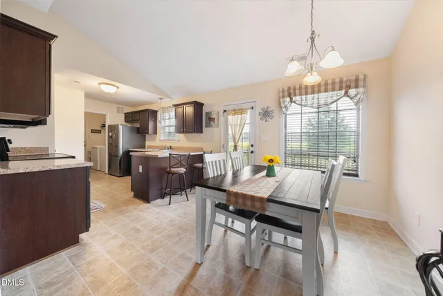 a living room with furniture a flat screen tv and a floor to ceiling window
