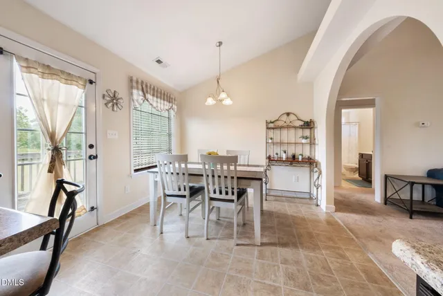 a dining room with furniture and a view of kitchen