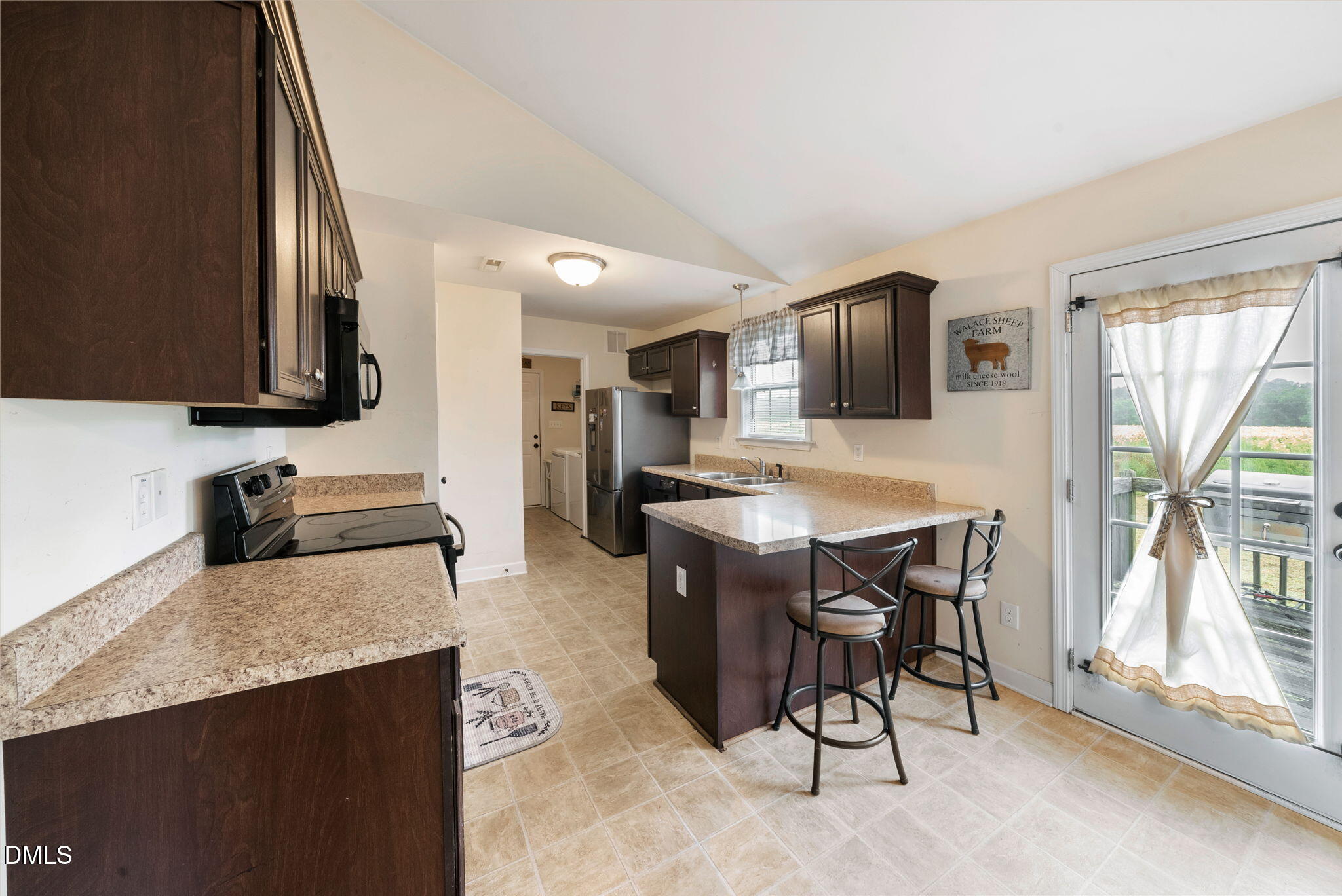 25 Lawrence Court Smithfield, NC 27577 - Photo 8 of 41 a kitchen with stainless steel appliances granite countertop a stove a sink a microwave and a refrigerator