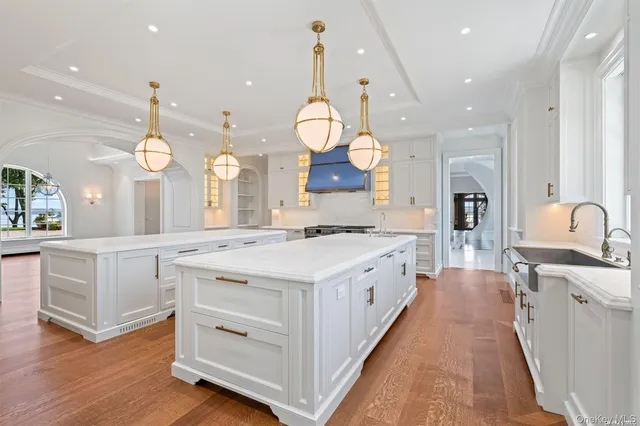 a kitchen with granite countertop a refrigerator and a sink