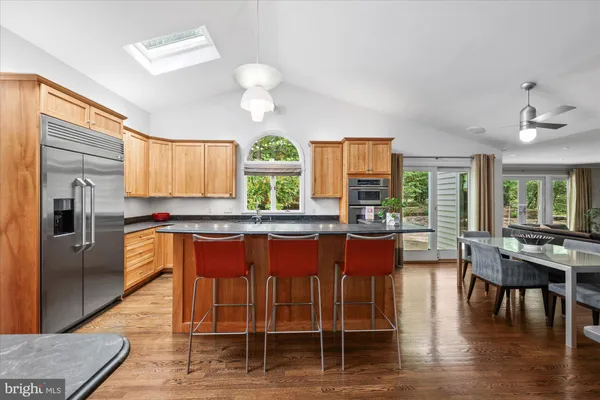 a kitchen with granite countertop wooden cabinets and stainless steel appliances