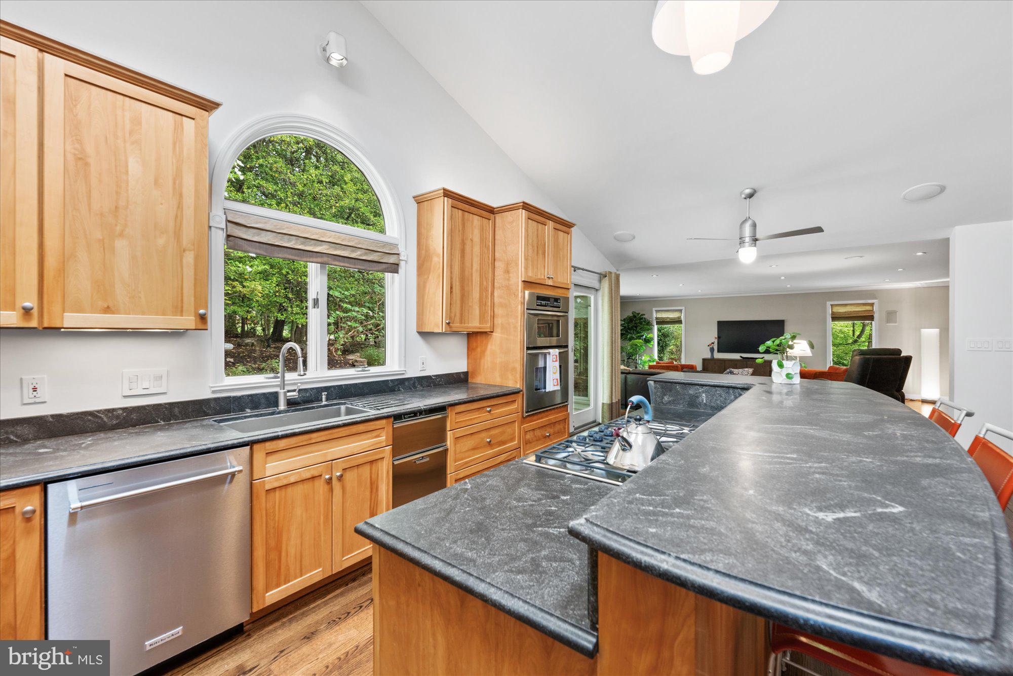 7908 Foxhound Road McLean, VA 22102 - Photo 16 of 48 a kitchen with stainless steel appliances granite countertop sink stove and cabinets