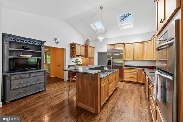 a kitchen with granite countertop a stove top oven and sink