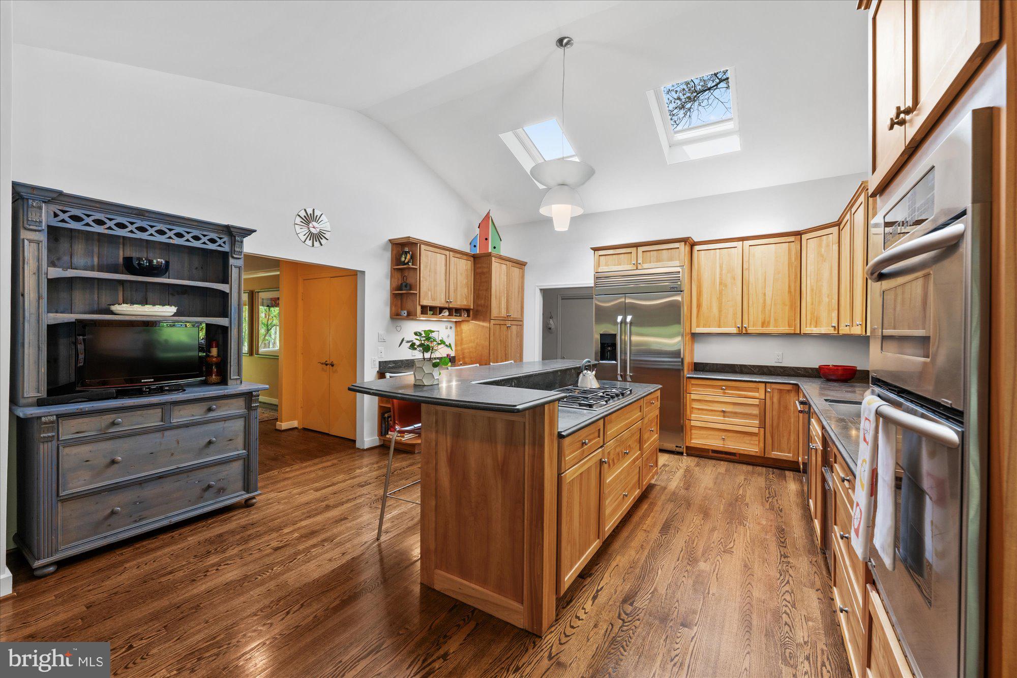 7908 Foxhound Road McLean, VA 22102 - Photo 17 of 48 a kitchen with granite countertop a stove top oven and sink