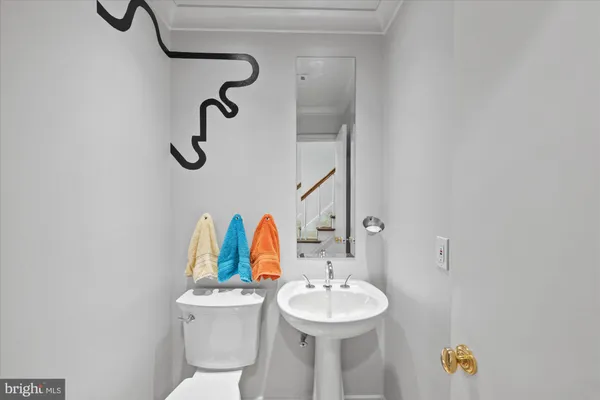 a bathroom with a sink mirror and toilet