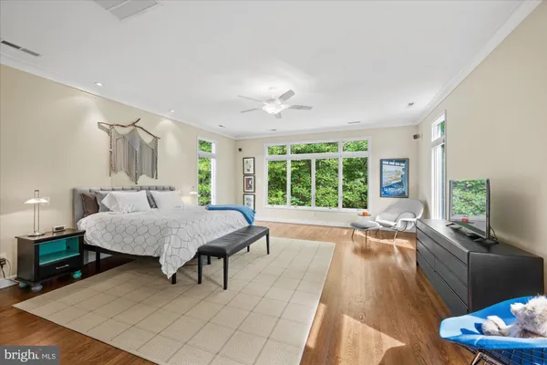 a spacious bedroom with a bed and a large window