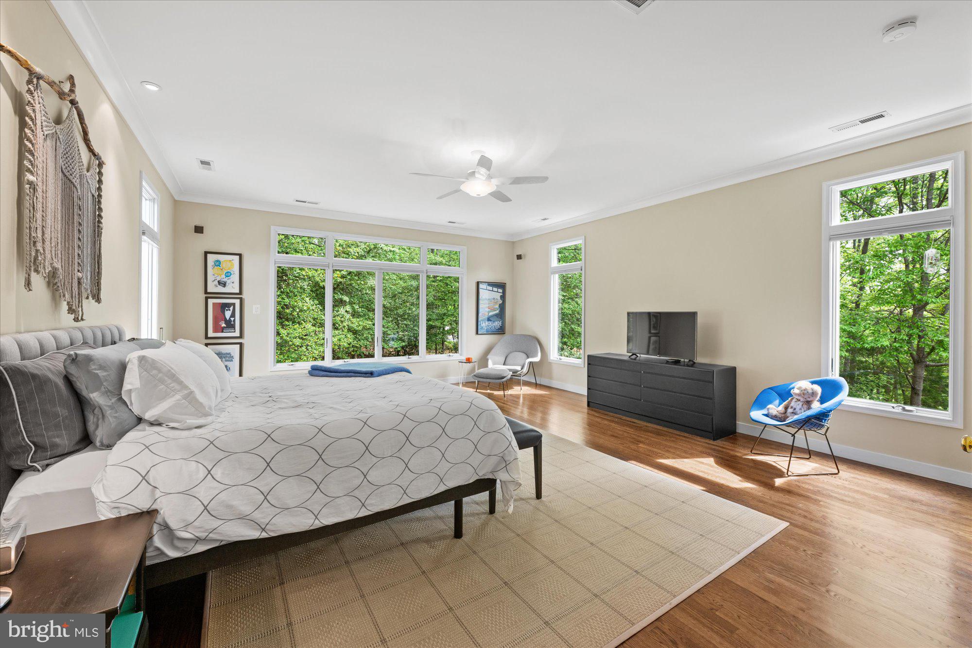 7908 Foxhound Road McLean, VA 22102 - Photo 28 of 48 a spacious bedroom with a bed and large windows