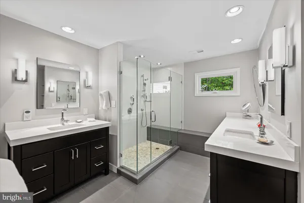a spacious bathroom with a double vanity sink mirror and double