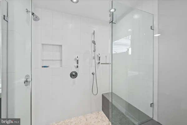 a bathroom with a shower and a glass door