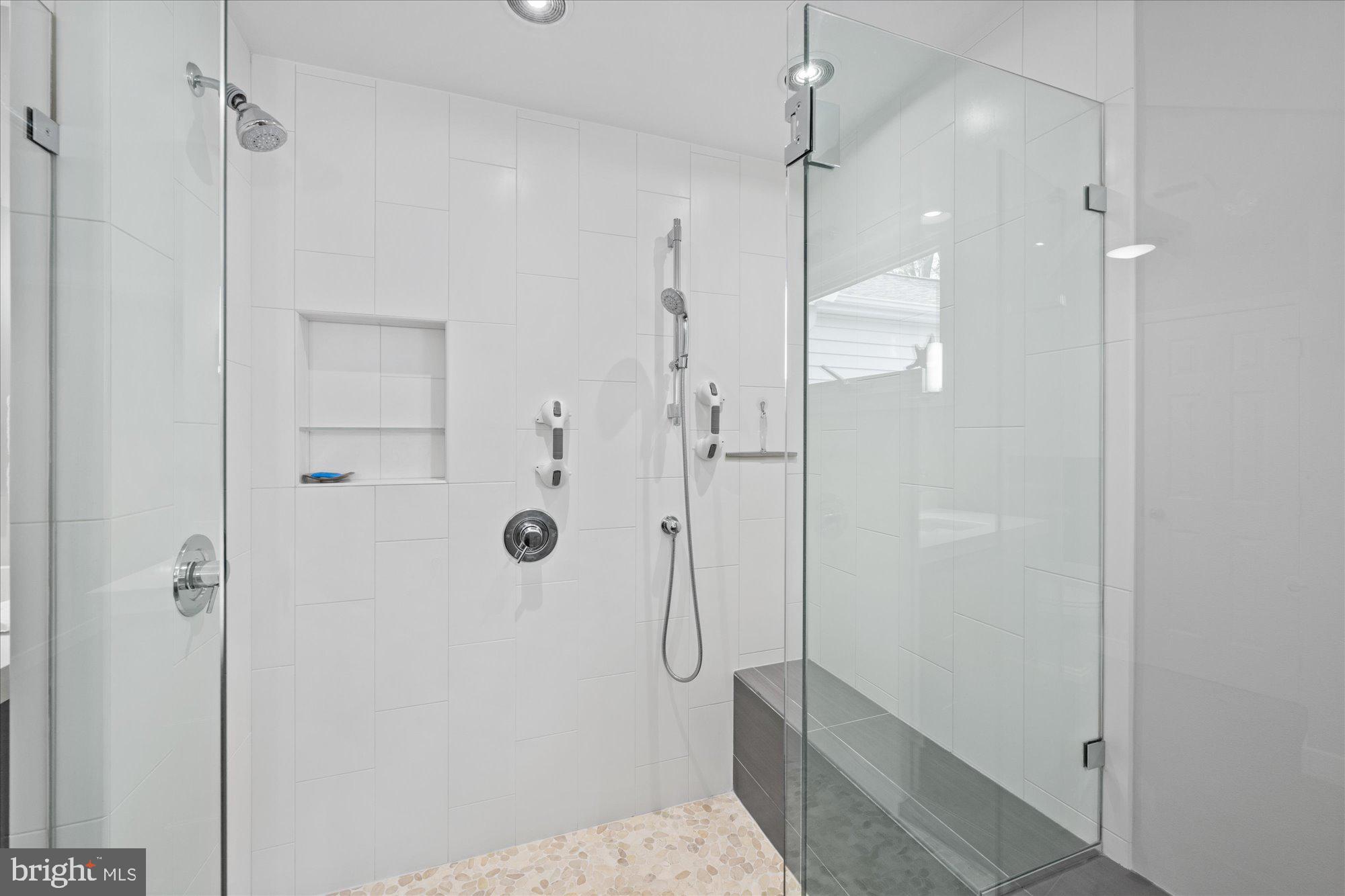 7908 Foxhound Road McLean, VA 22102 - Photo 34 of 48 a bathroom with a shower and a glass door