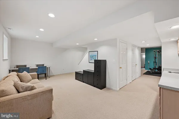 a living room with furniture and kitchen
