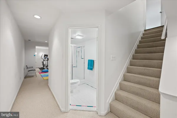 a view of a hallway with wooden floor and stairs