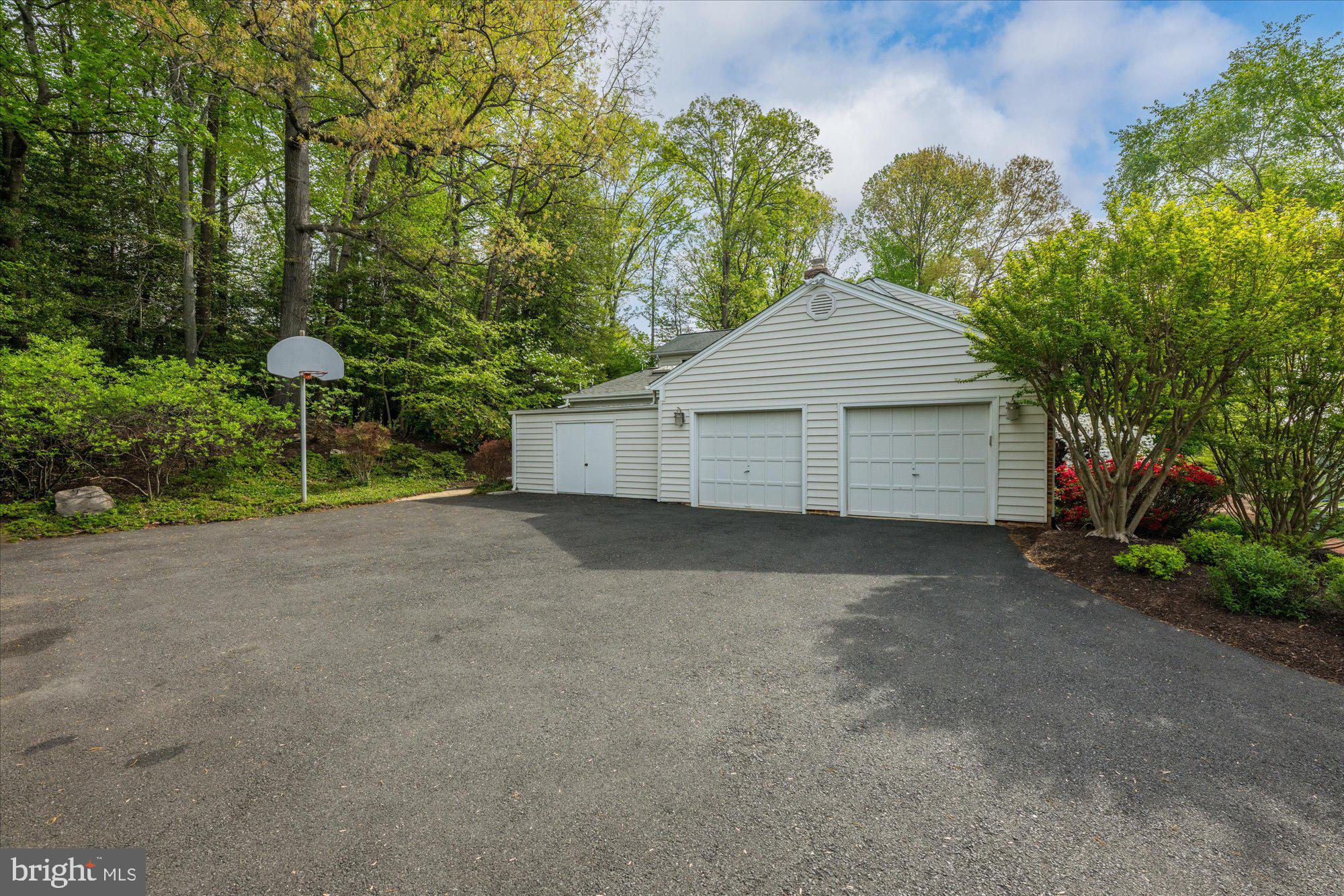 7908 Foxhound Road McLean, VA 22102 - Photo 43 of 48 a front view of a house with a yard and garage