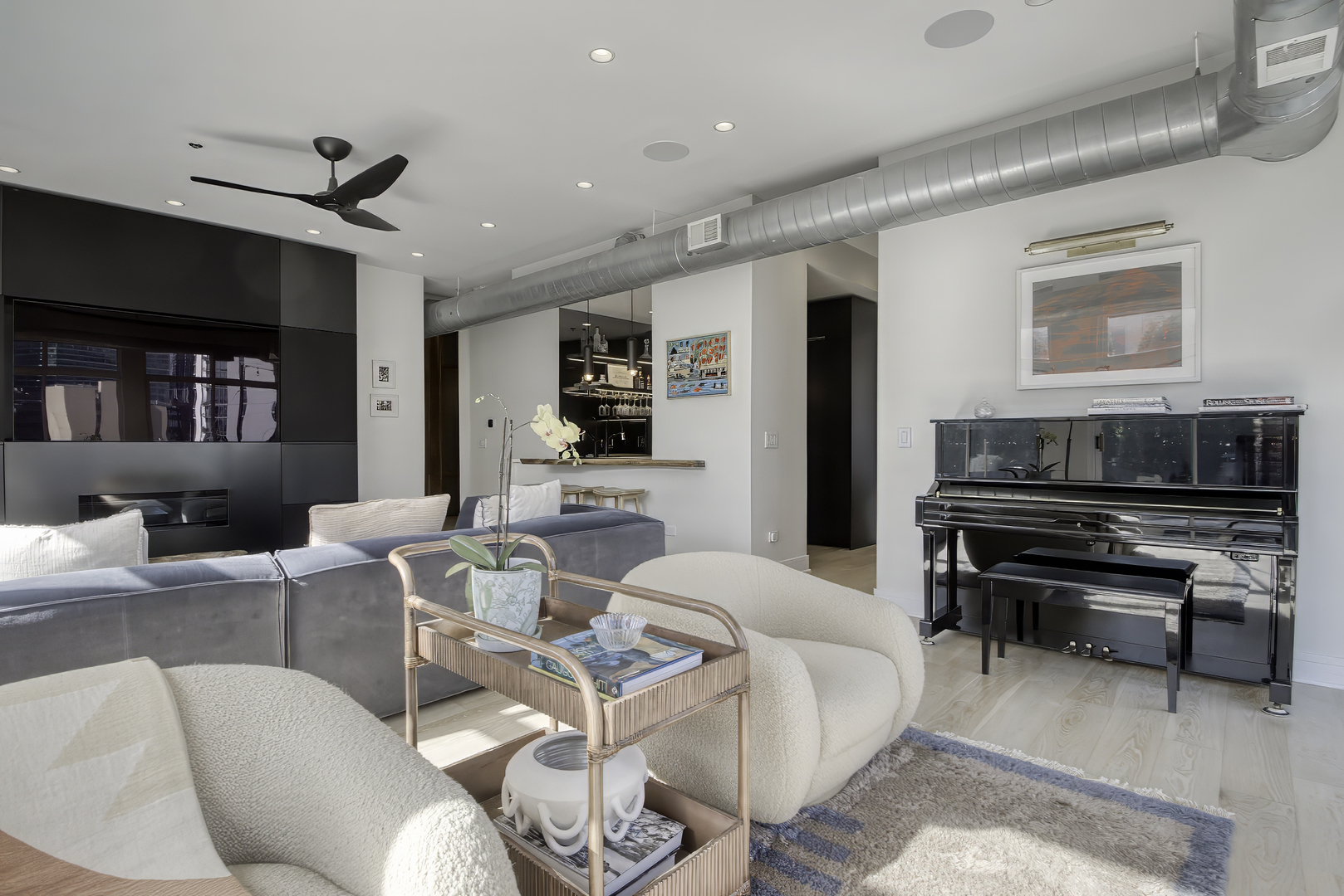 910 West Madison Street, Unit 904E Chicago, IL 60607 - Photo 12 of 56 a living room with furniture a flat screen tv and kitchen view