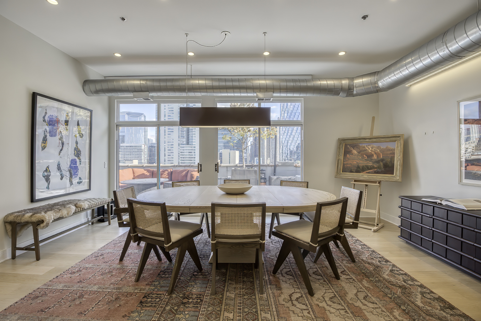910 West Madison Street, Unit 904E Chicago, IL 60607 - Photo 19 of 56 a dining room with furniture a rug and wooden floor