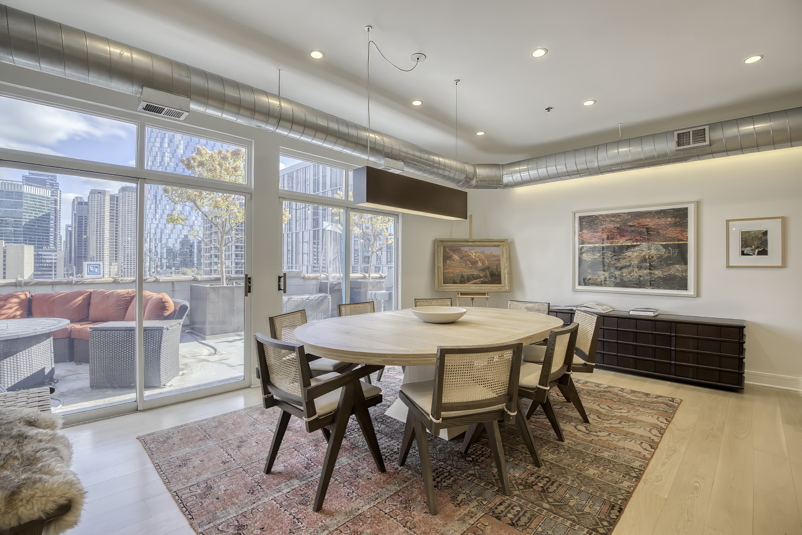 910 West Madison Street, Unit 904E Chicago, IL 60607 - Photo 20 of 56 a view of a dining room with furniture window and wooden floor