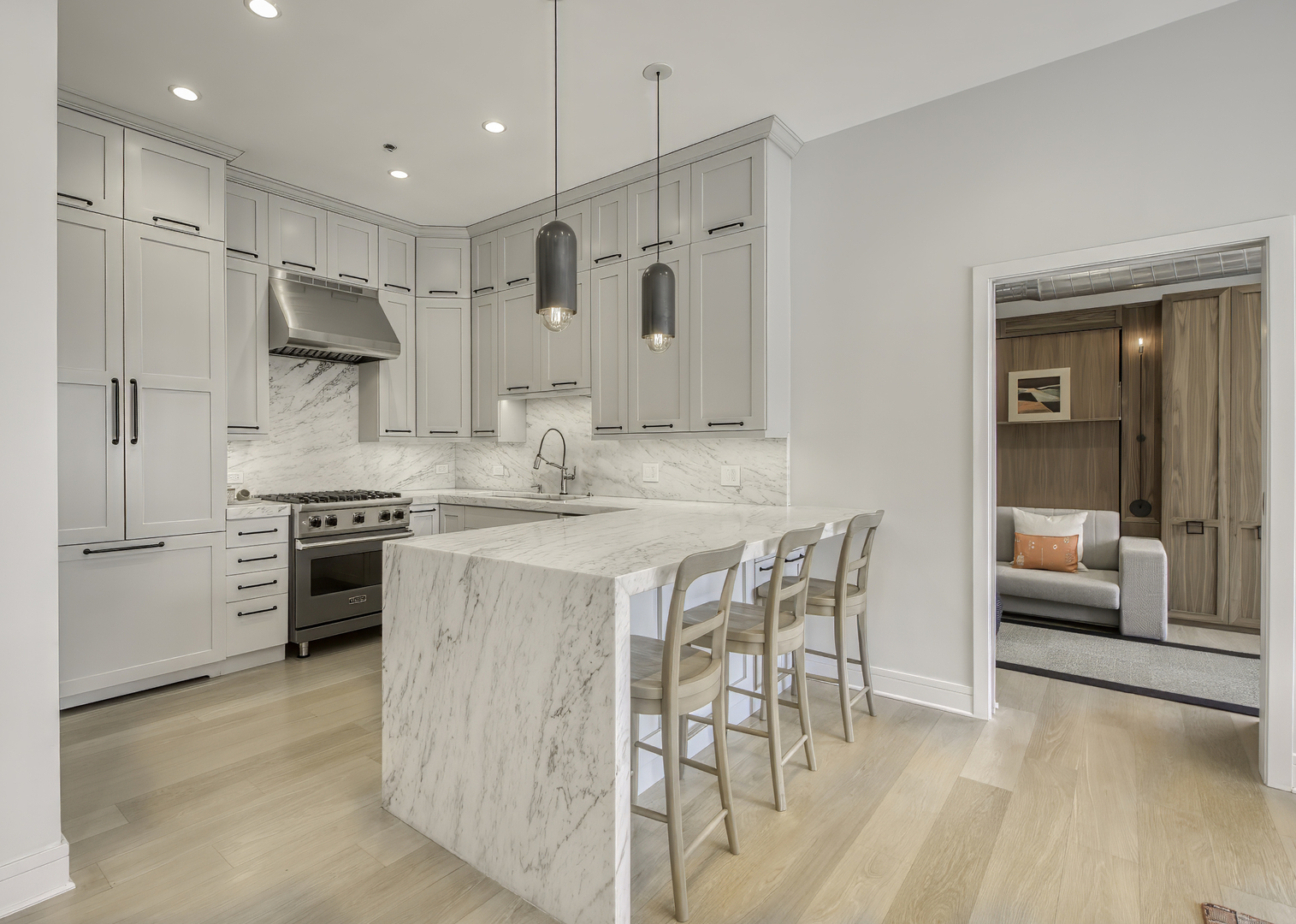 910 West Madison Street, Unit 904E Chicago, IL 60607 - Photo 22 of 56 a kitchen with stainless steel appliances kitchen island granite countertop a stove a sink a refrigerator and white cabinets with wooden floor