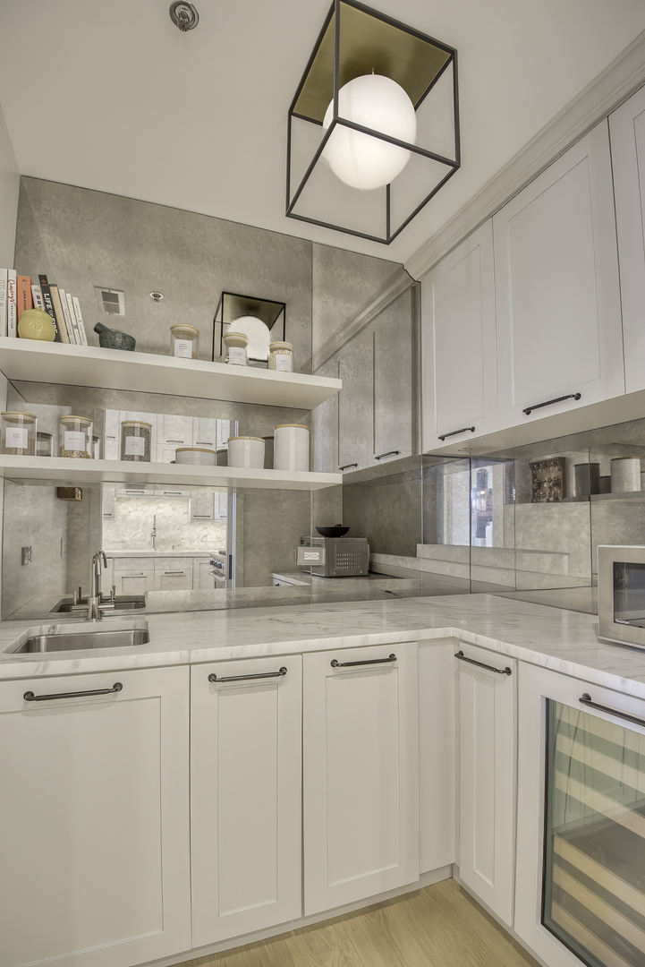 910 West Madison Street, Unit 904E Chicago, IL 60607 - Photo 27 of 56 a kitchen with granite countertop white cabinets and white appliances