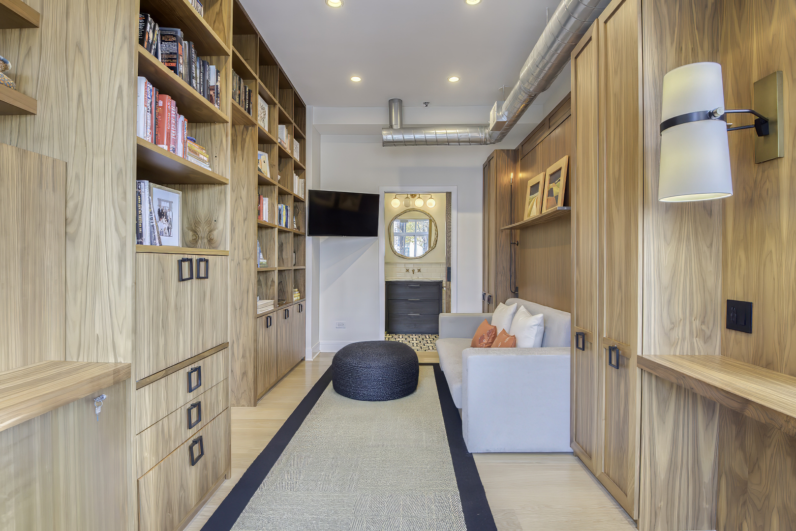 910 West Madison Street, Unit 904E Chicago, IL 60607 - Photo 39 of 56 a hallway with furniture and a book shelf