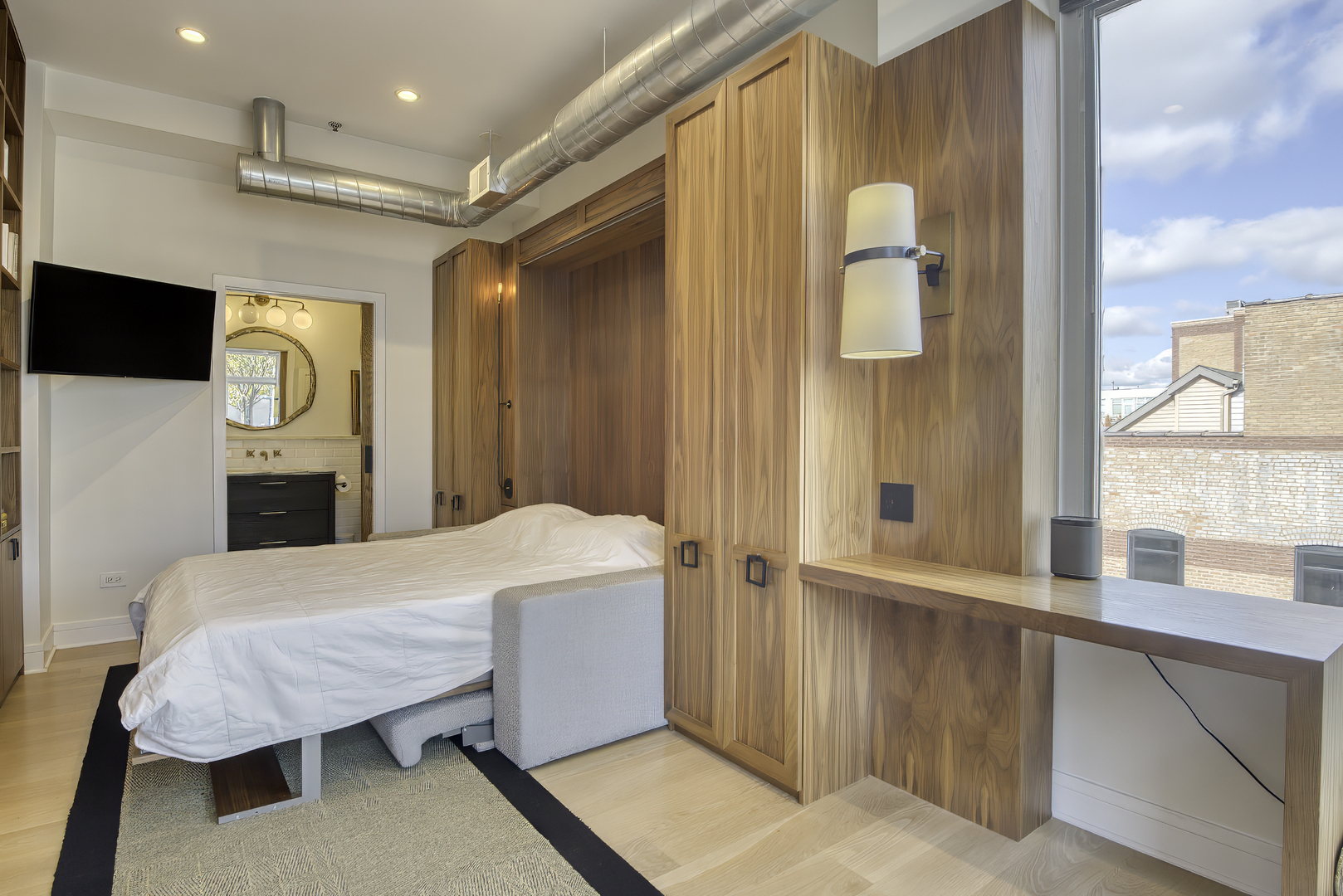 910 West Madison Street, Unit 904E Chicago, IL 60607 - Photo 41 of 56 a bedroom with a bed dresser and a window