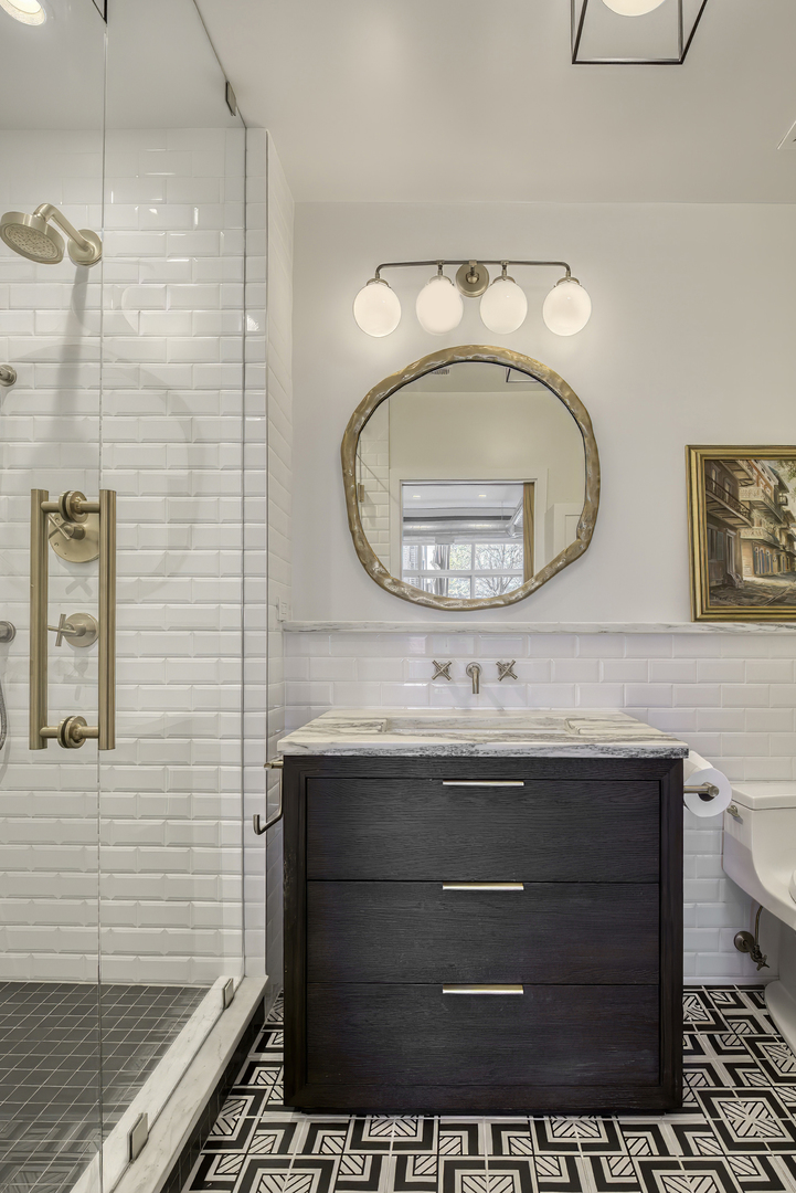 910 West Madison Street, Unit 904E Chicago, IL 60607 - Photo 42 of 56 a bathroom with a sink a toilet and a mirror