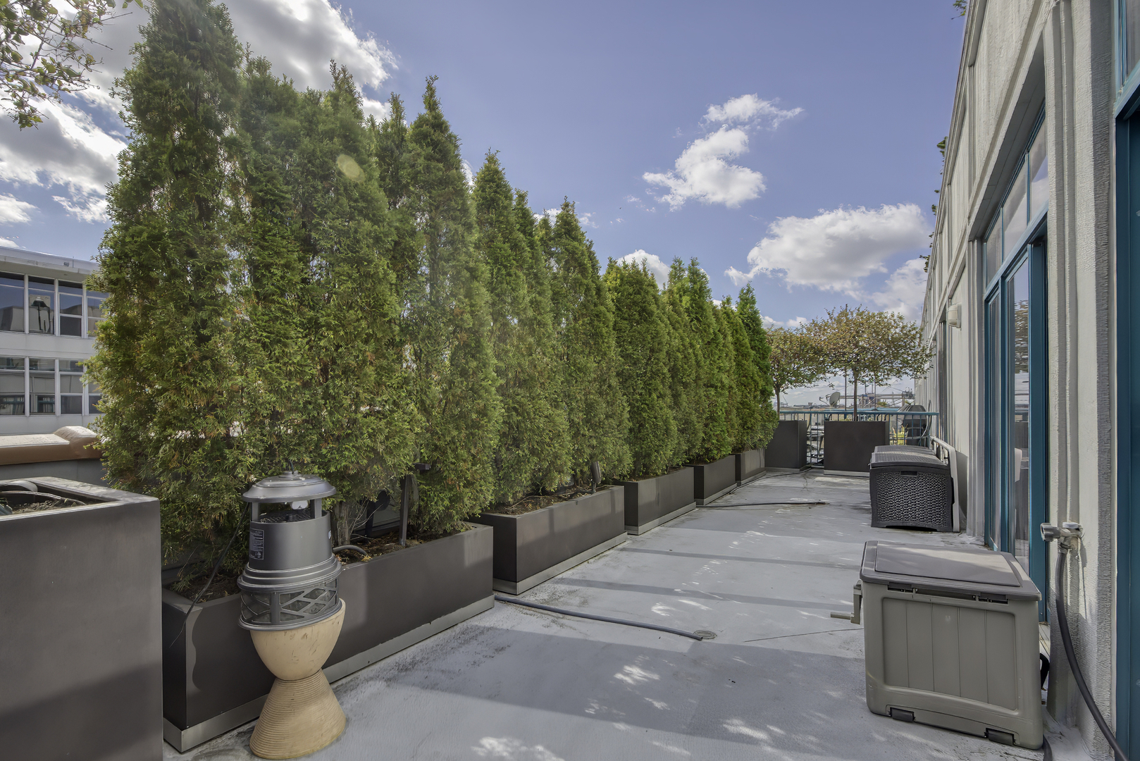 910 West Madison Street, Unit 904E Chicago, IL 60607 - Photo 50 of 56 a view of a patio with couches and potted plants