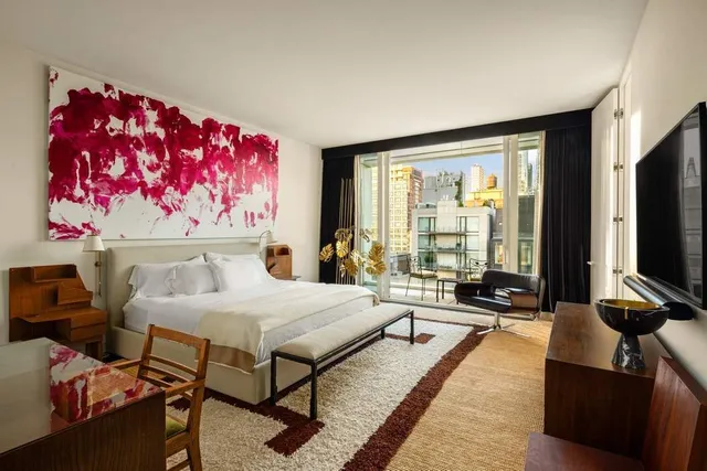 a bedroom with a bed and glass window