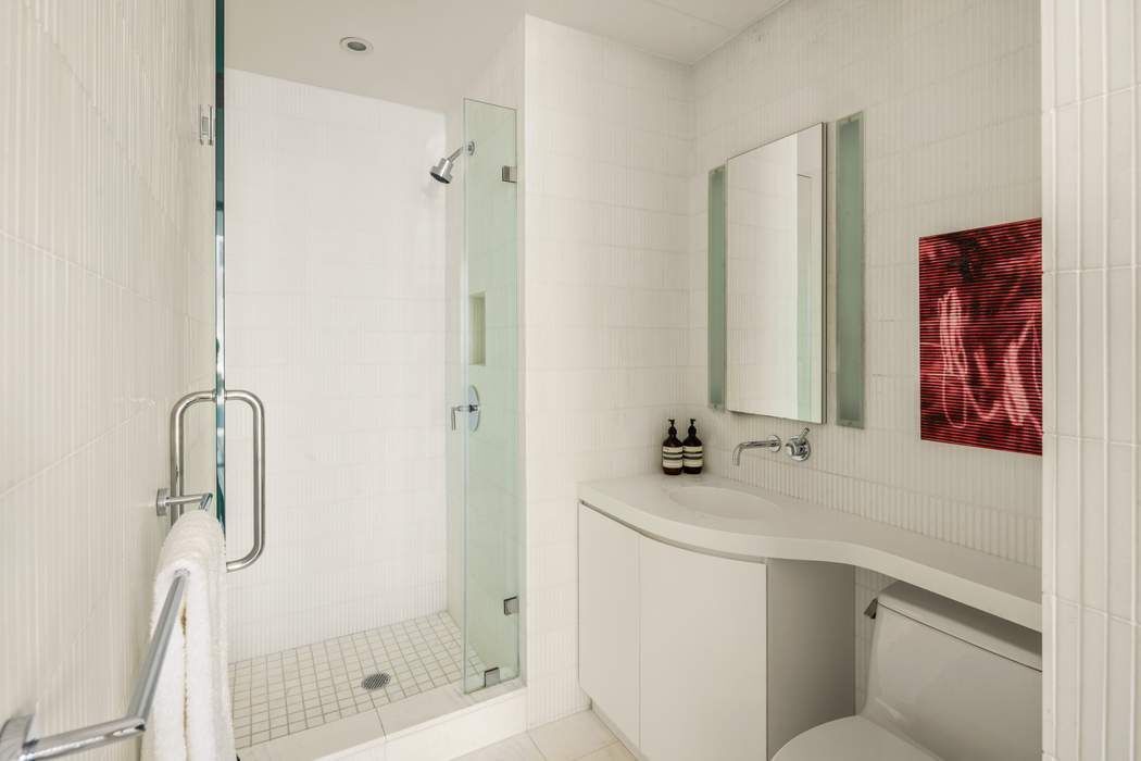 524 West 19th Street, Unit PH Manhattan, NY 10011 - Photo 20 of 27 a bathroom with a shower sink and mirror