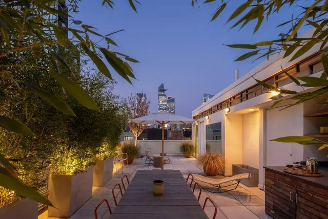 a balcony with couple of flower plants