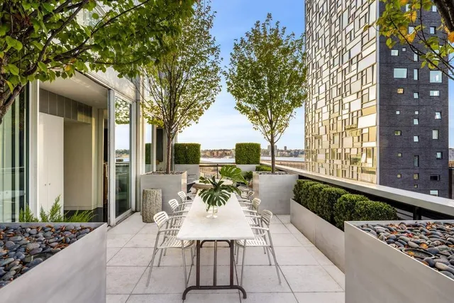 a view of a patio with couches table and chairs and potted plants