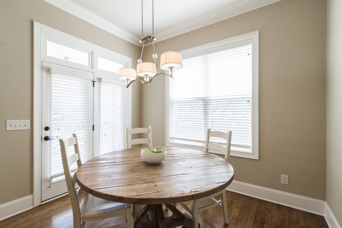 192 Barlow Drive Franklin, TN 37064 - Photo 13 of 36 a dining room with wooden floor a chandelier a wooden table and chairs