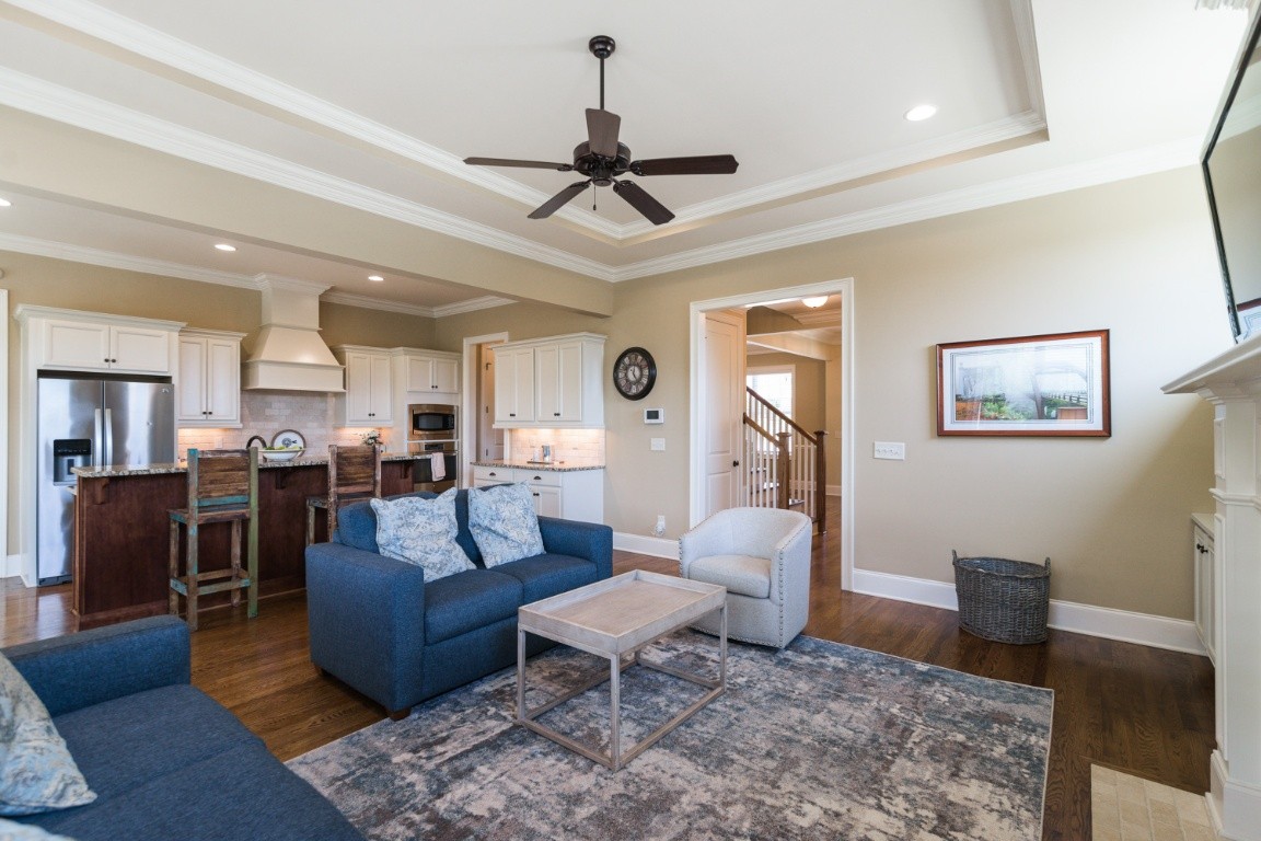 192 Barlow Drive Franklin, TN 37064 - Photo 8 of 36 a living room with furniture a wooden floor and a chandelier
