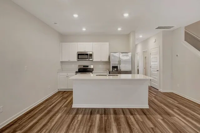 a view of kitchen with sink microwave and stove