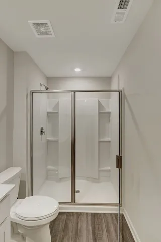 a bathroom with a glass shower door