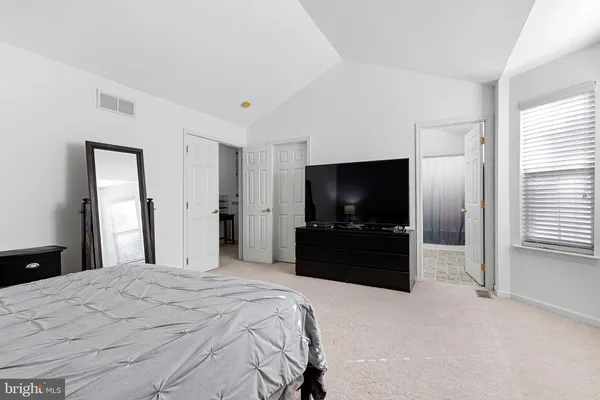 a bedroom with a bed and a night stand