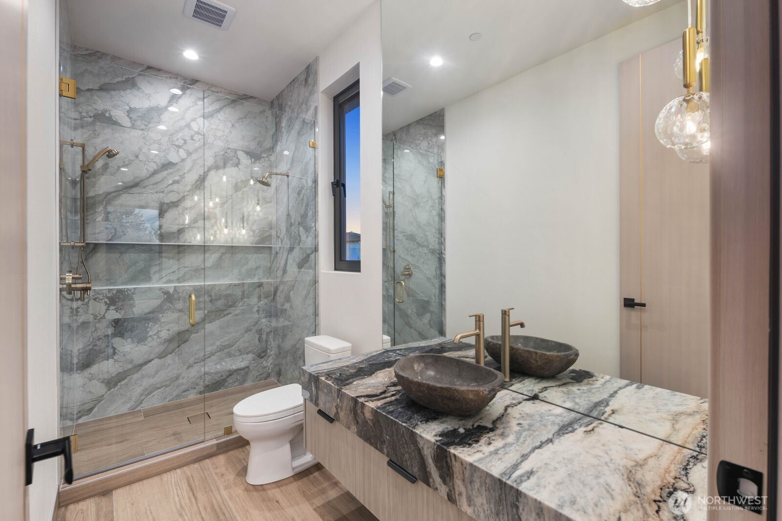 4599 Northwest 71st Avenue Camas, WA 98607 - Photo 40 of 40 a bathroom with a granite countertop sink a toilet a mirror and shower