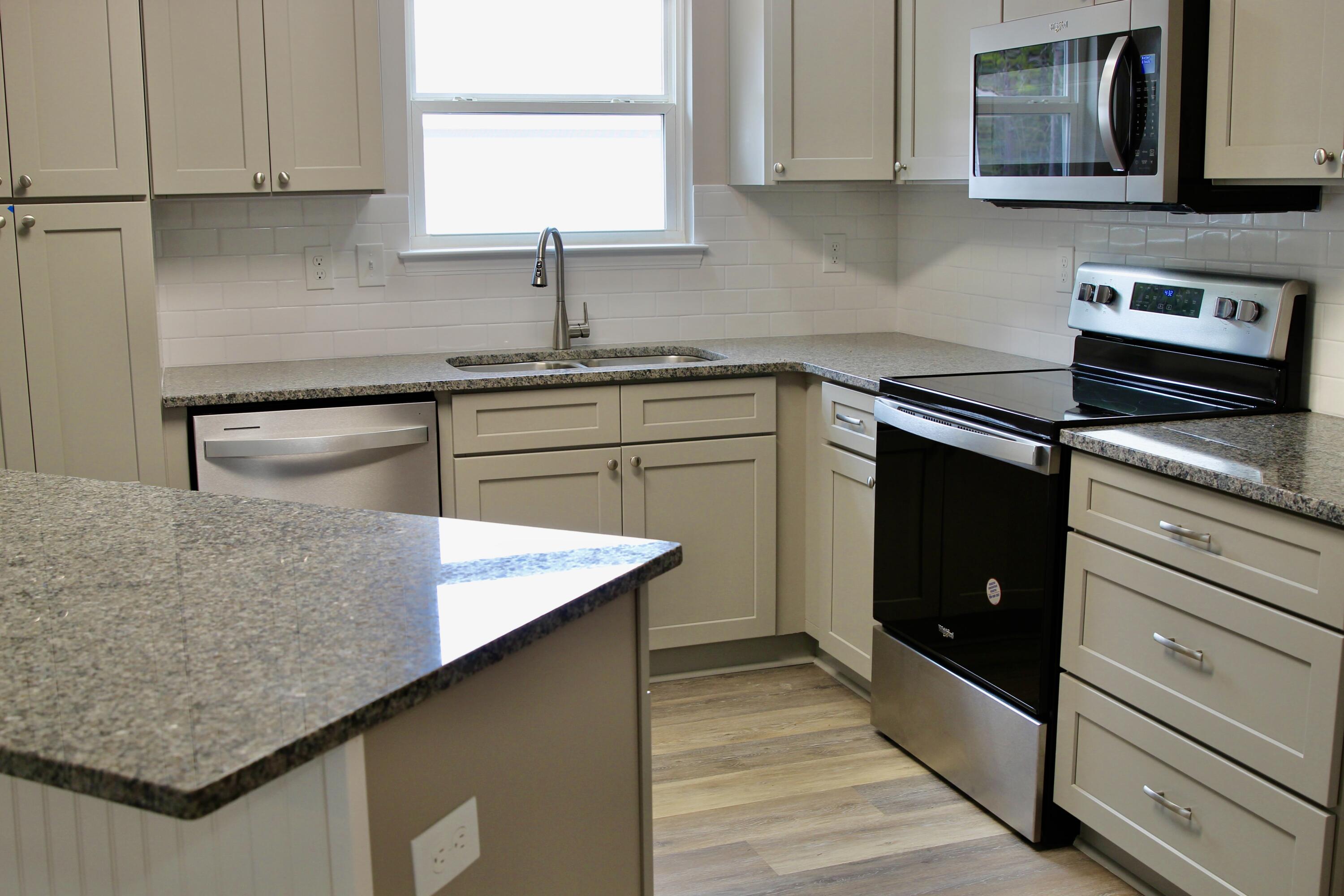 4639 Falcon Way Crestview, FL 32539 - Photo 11 of 40 a kitchen with granite countertop cabinets stainless steel appliances and a sink