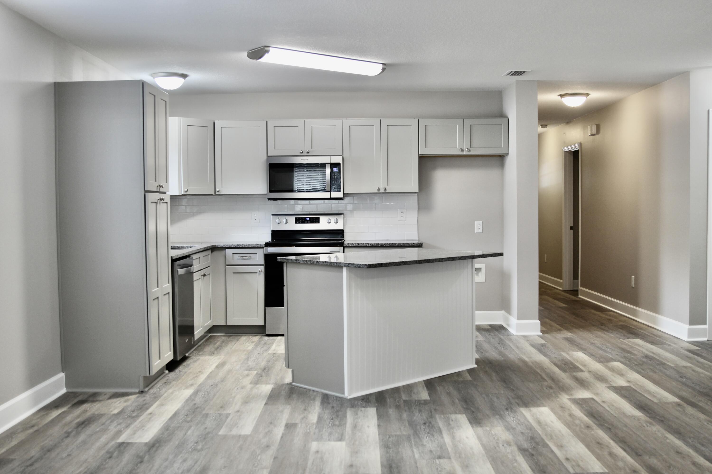 4639 Falcon Way Crestview, FL 32539 - Photo 13 of 40 a kitchen with stainless steel appliances a refrigerator stove a sink and white cabinets