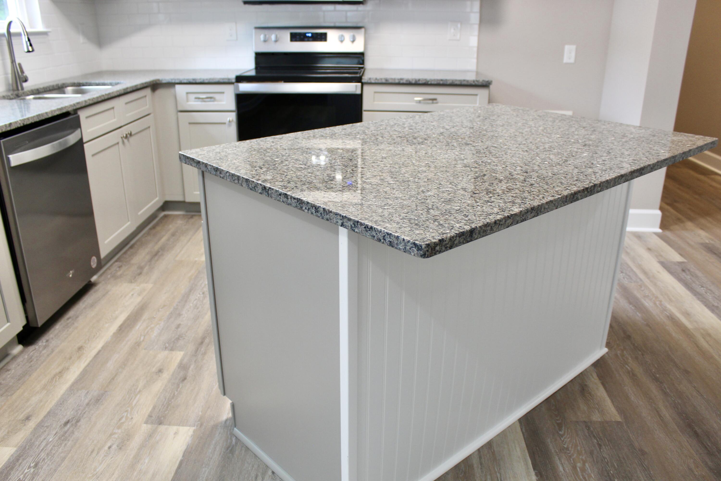 4639 Falcon Way Crestview, FL 32539 - Photo 18 of 40 a kitchen with granite countertop a sink and stove