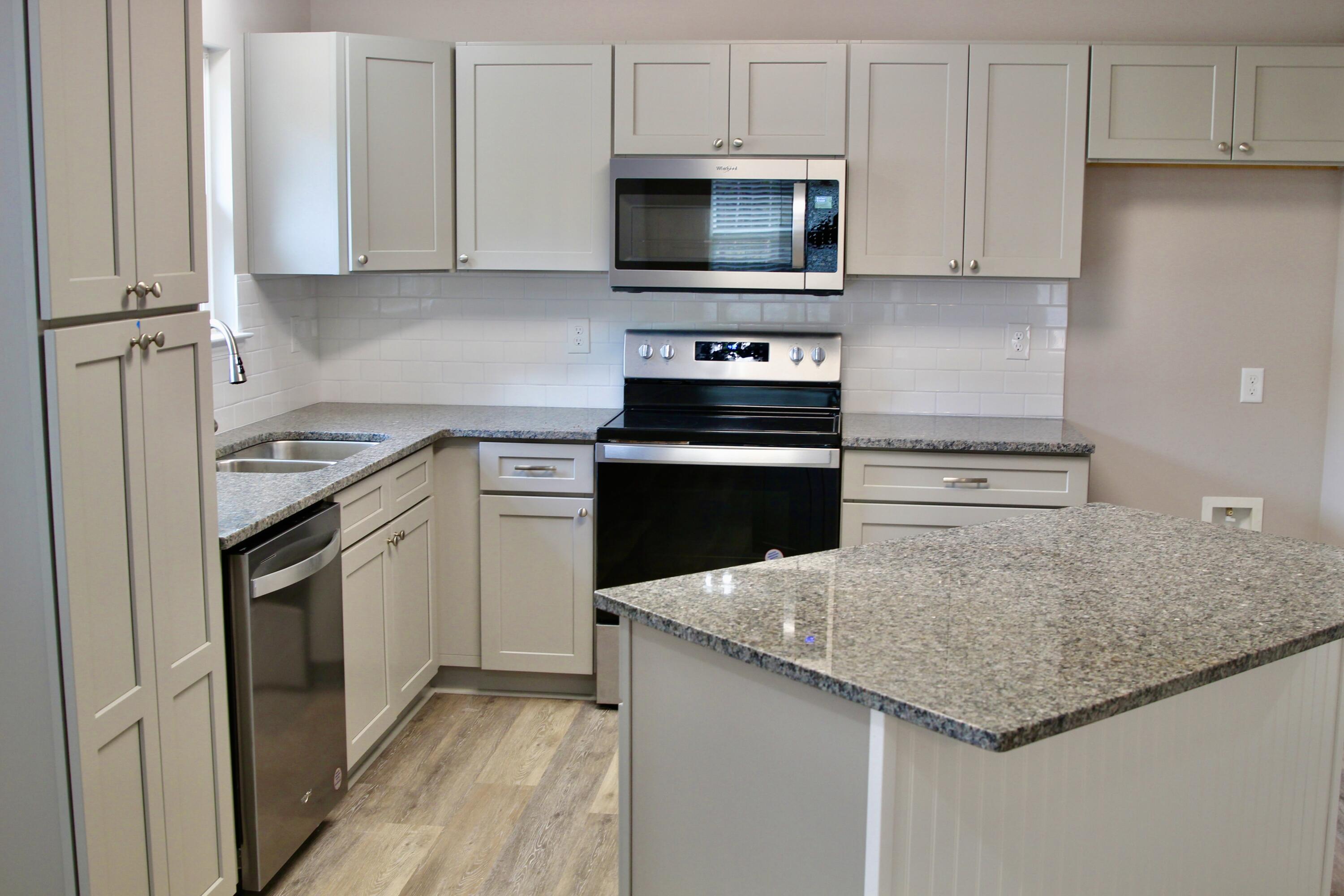 4639 Falcon Way Crestview, FL 32539 - Photo 21 of 40 a kitchen with cabinets appliances a sink and a counter top space