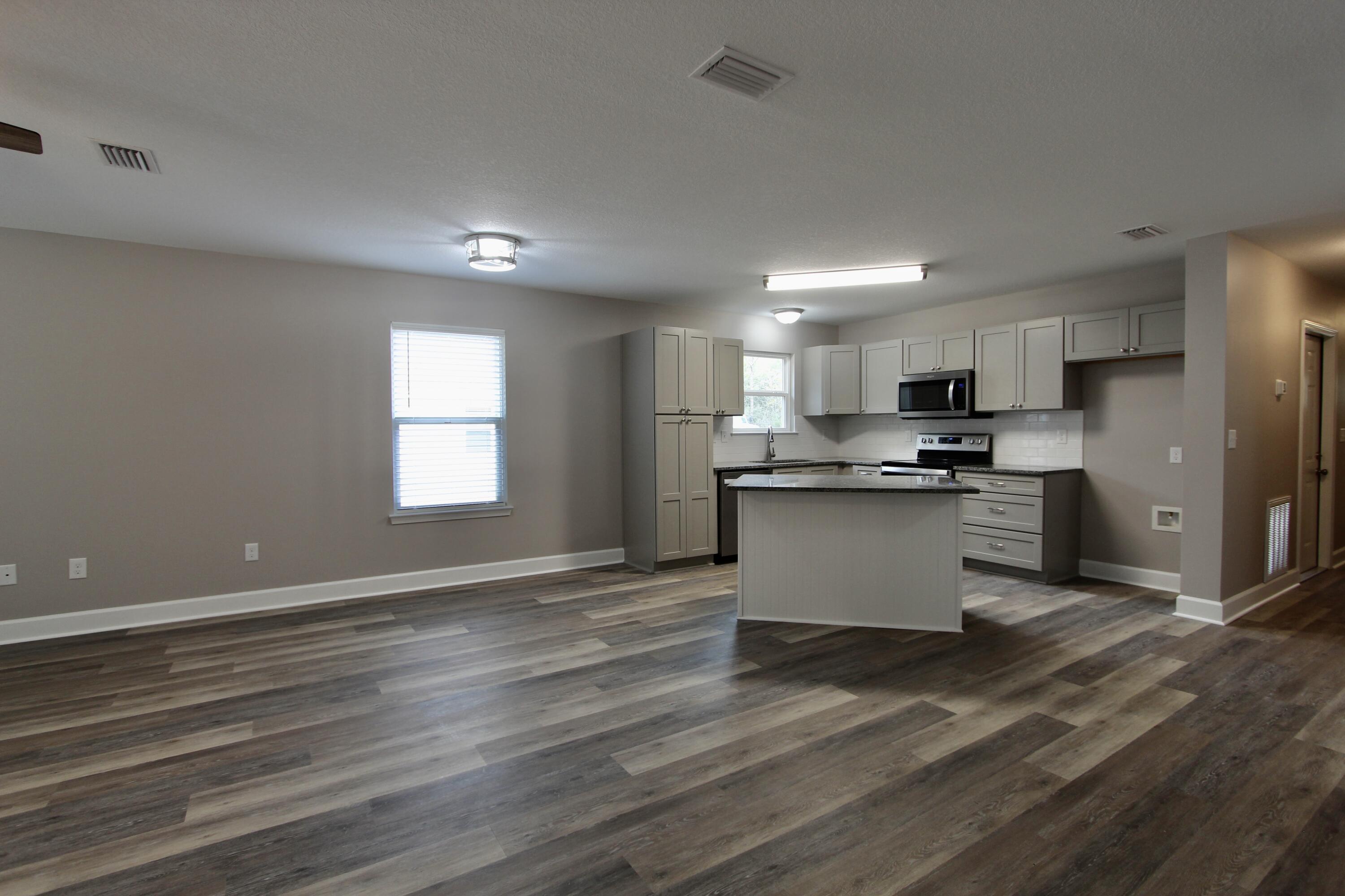 4639 Falcon Way Crestview, FL 32539 - Photo 23 of 40 a kitchen with stainless steel appliances granite countertop a refrigerator and a stove top oven
