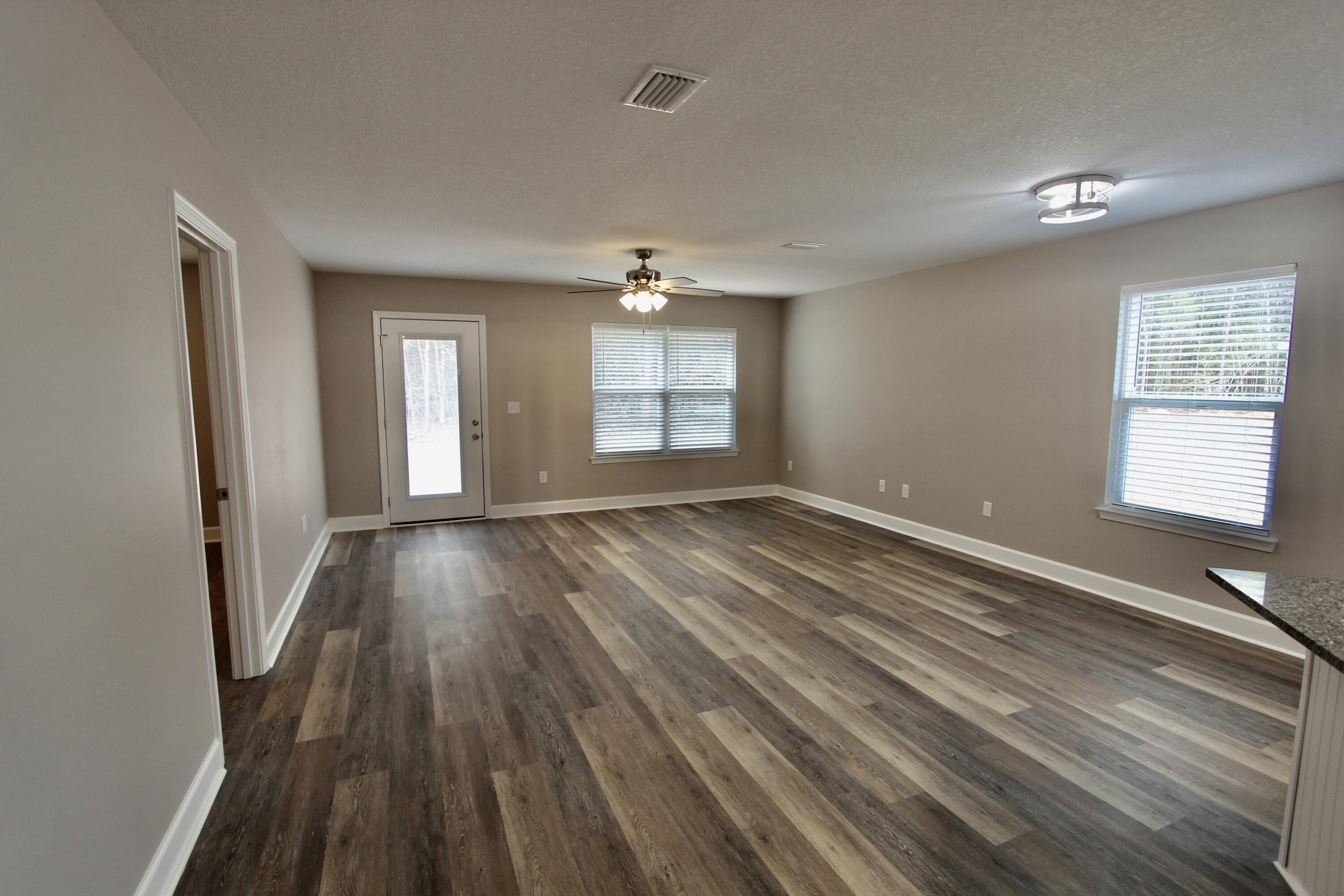4639 Falcon Way Crestview, FL 32539 - Photo 24 of 40 wooden floor in an empty room with a window