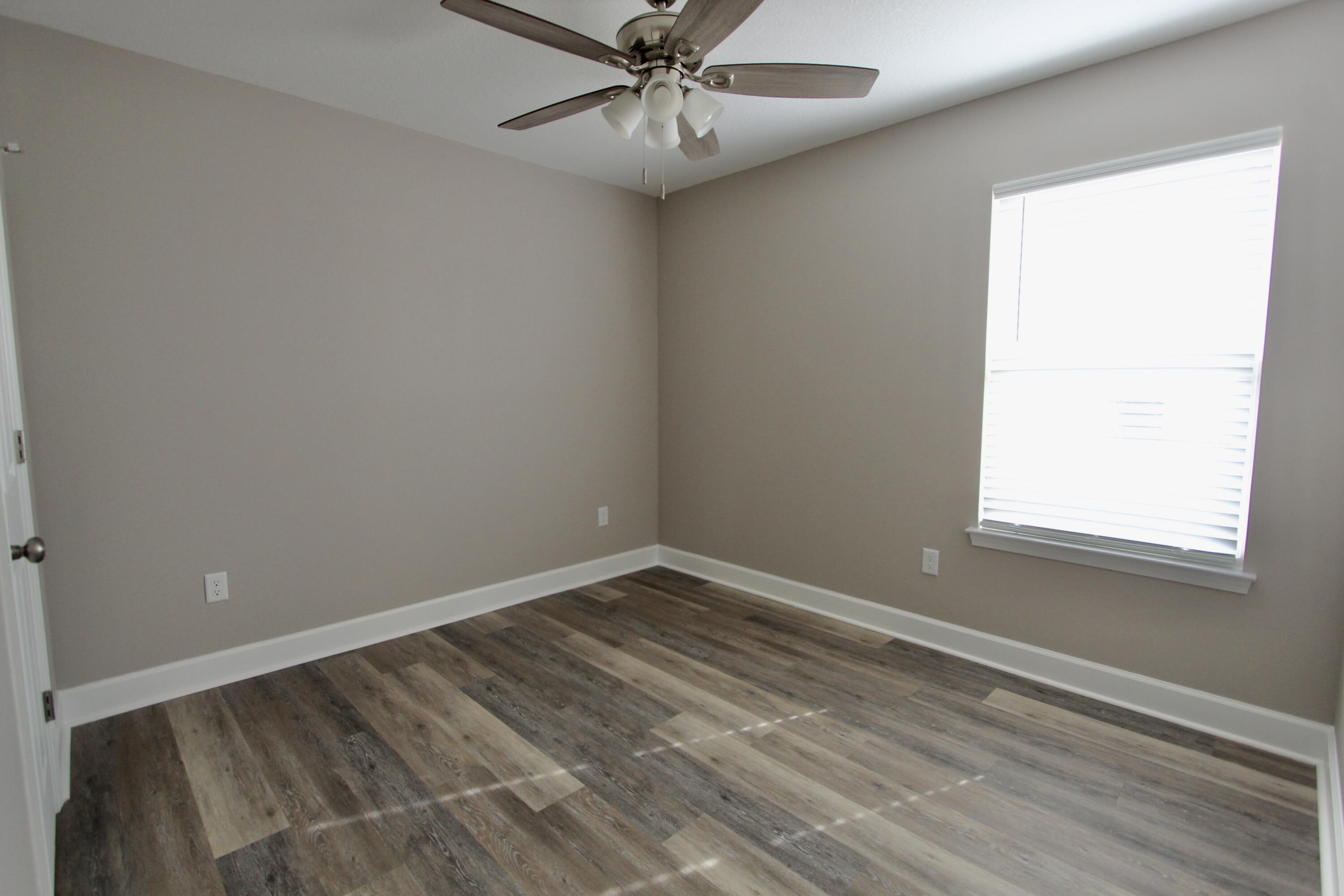 4639 Falcon Way Crestview, FL 32539 - Photo 28 of 40 an empty room with a window and a fan